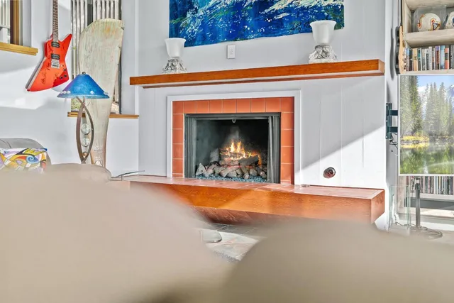 a view of a fireplace with window and table in the house