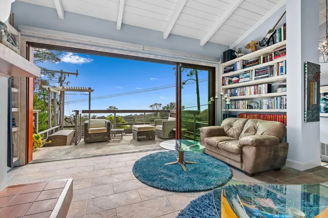 a living room with furniture and a painting on the wall