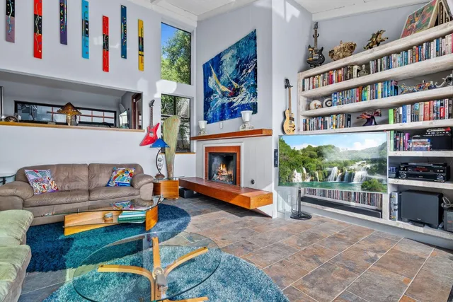 a living room with fireplace furniture and a book shelf