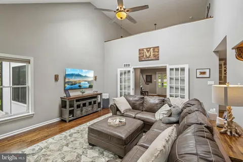 a kitchen with kitchen island a large window a sink appliances and cabinets