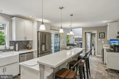 a kitchen with a stove a sink and a refrigerator