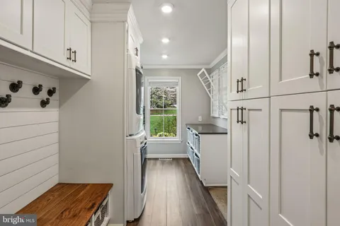 a kitchen with granite countertop white cabinets and a window