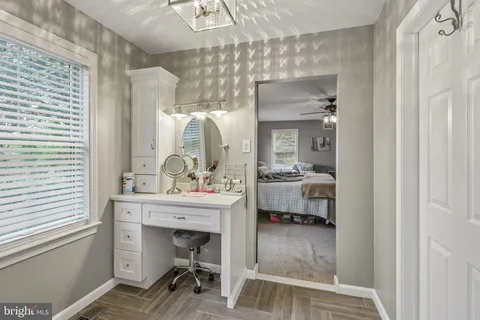 a bathroom with a sink a toilet and a window