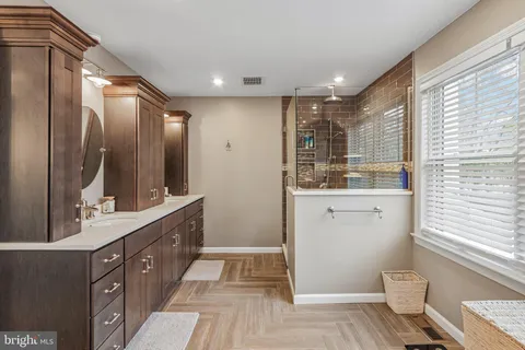a kitchen with stainless steel appliances kitchen island granite countertop a table and chairs in it