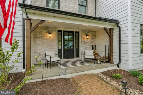 a front view of a house with outdoor seating and plants