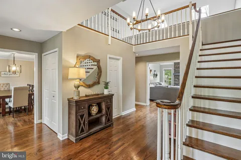 a view of entryway livingroom and hall with wooden floor