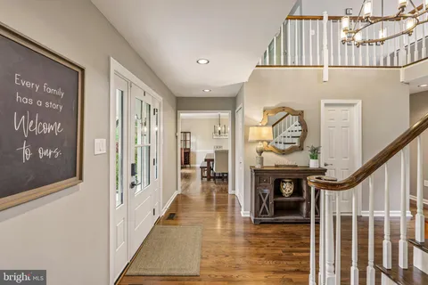 a view of a hallway with entryway wooden floor and front door