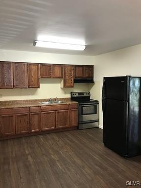 1538 East 8th Street, Unit A Bethlehem, PA 18015 - Photo 6 of 31 a kitchen with granite countertop a refrigerator and a stove top oven