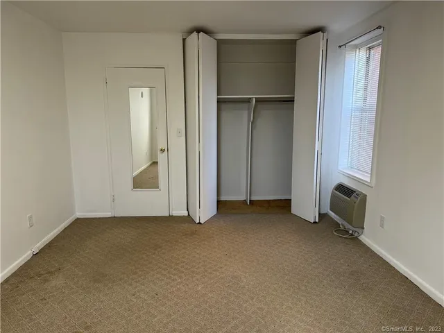 an empty room with closet area