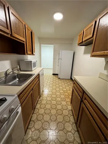 a kitchen with sink cabinets and window