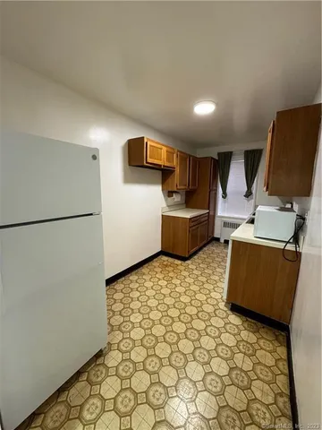 a room with furniture and a refrigerator