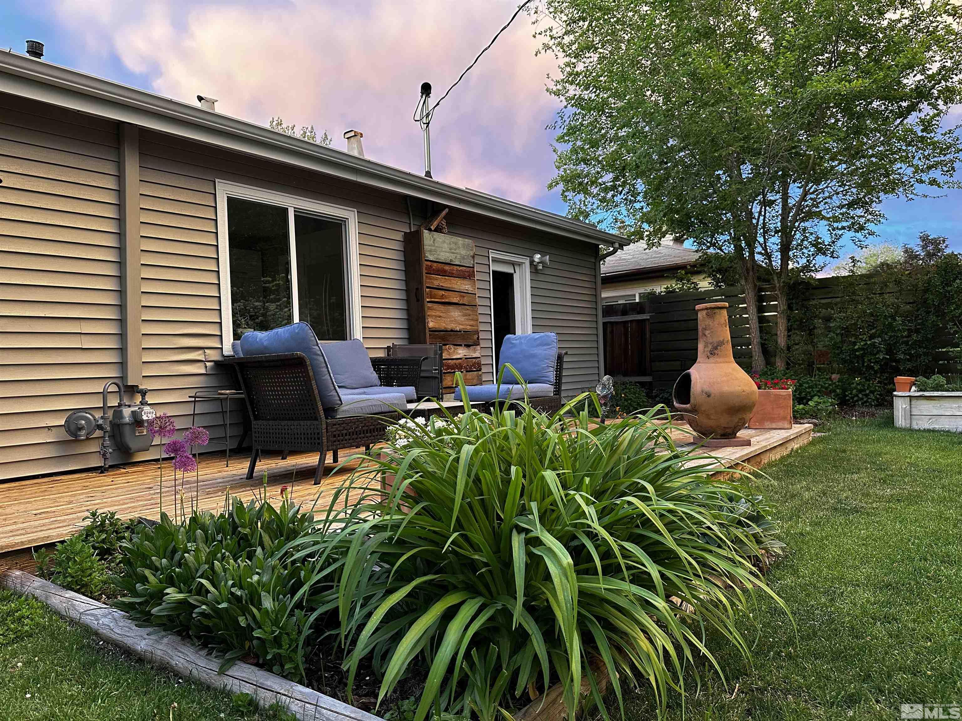 798 Broadway Boulevard Reno, NV 89502 - Photo 11 of 12 a backyard of a house with table and chairs potted plants and large tree
