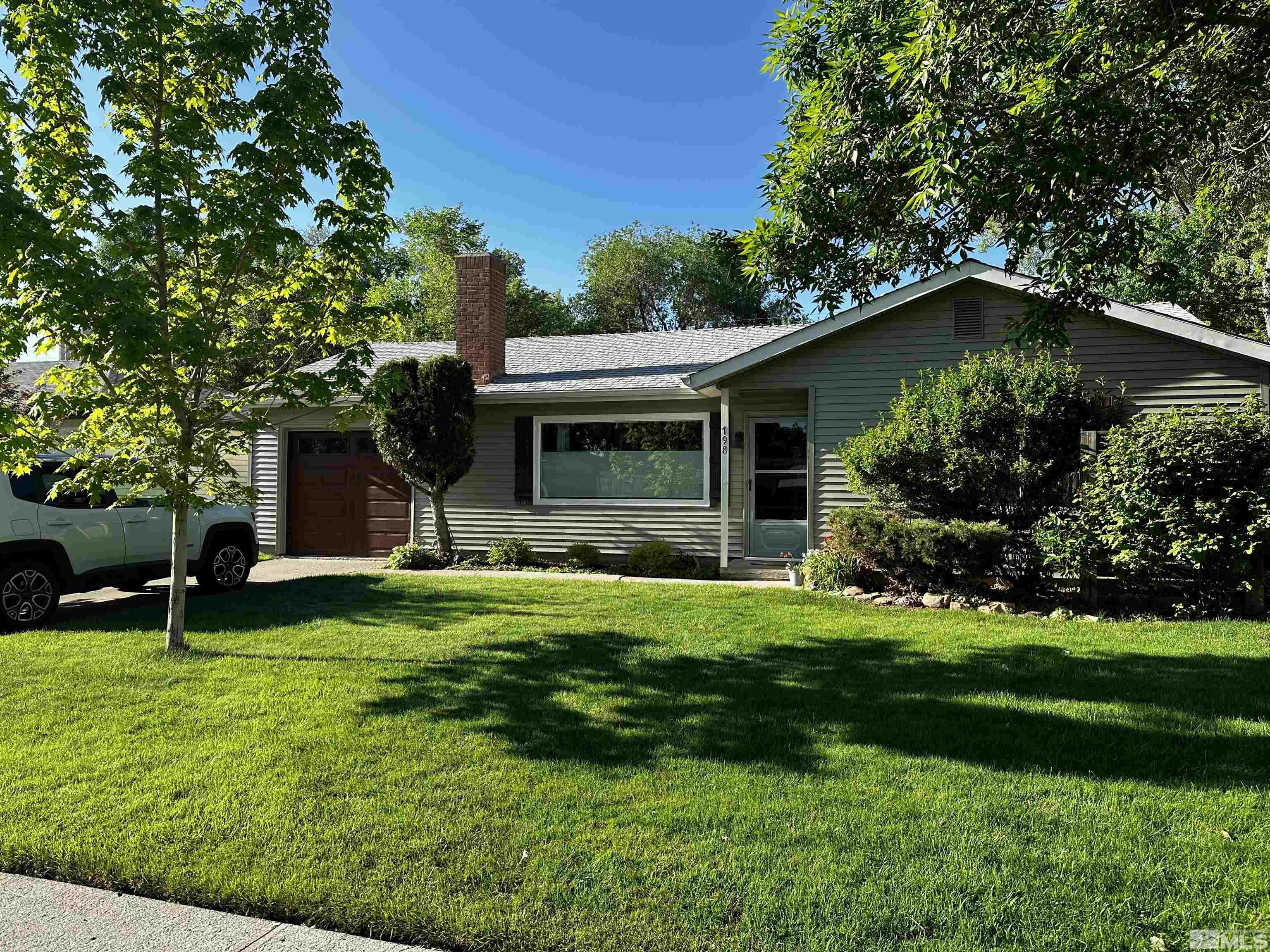 798 Broadway Boulevard Reno, NV 89502 - Photo 9 of 12 a view of a house with a yard and a large tree