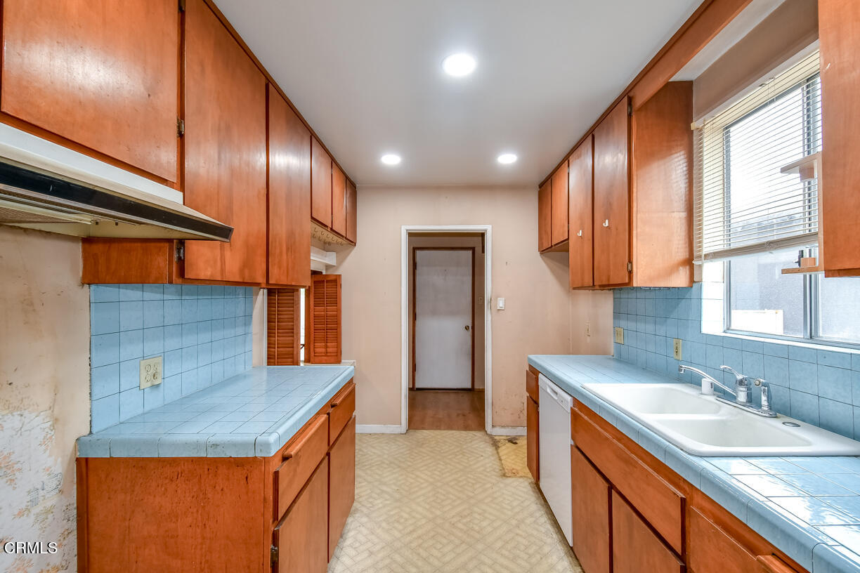 9533 Burma Road Pico Rivera, CA 90660 - Photo 11 of 17 a kitchen with stainless steel appliances granite countertop counter space cabinets and a sink