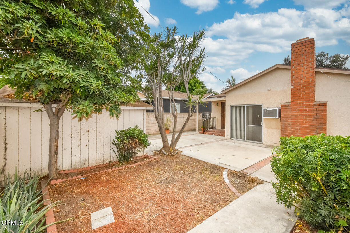 9533 Burma Road Pico Rivera, CA 90660 - Photo 14 of 17 a view of a house with a backyard and a tree