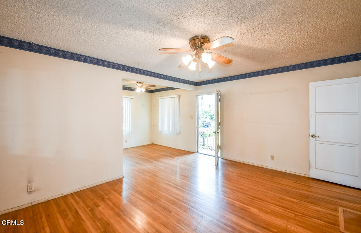 9533 Burma Road Pico Rivera, CA 90660 - Photo 5 of 17 a view of an empty room with wooden floor and a window