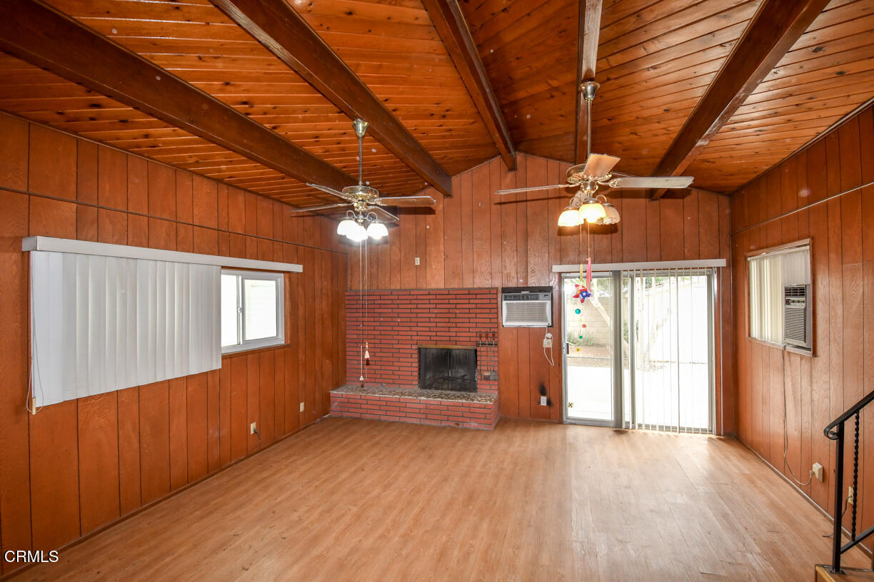9533 Burma Road Pico Rivera, CA 90660 - Photo 7 of 17 a view of an empty room with a fireplace and a window
