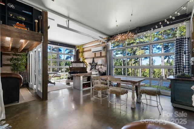 a living room with lots of furniture and a large window