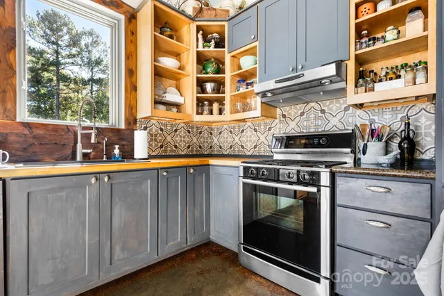 a kitchen with stainless steel appliances granite countertop a stove and a sink