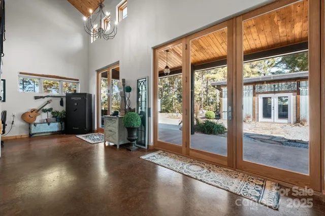 a view of a livingroom with furniture wooden floor and windows