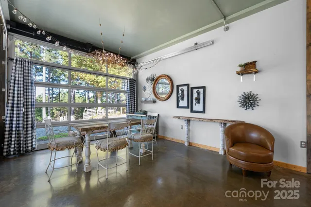 a living room with couches and a large window with outer view