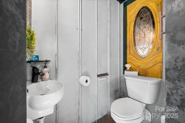 a bed room with a bed and a painting on the wall