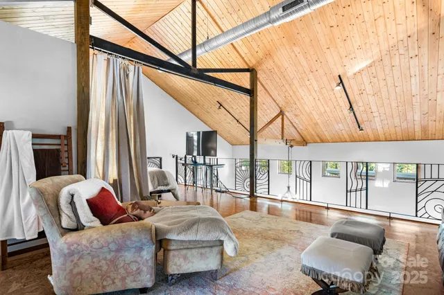 a bedroom with furniture and a wooden floor