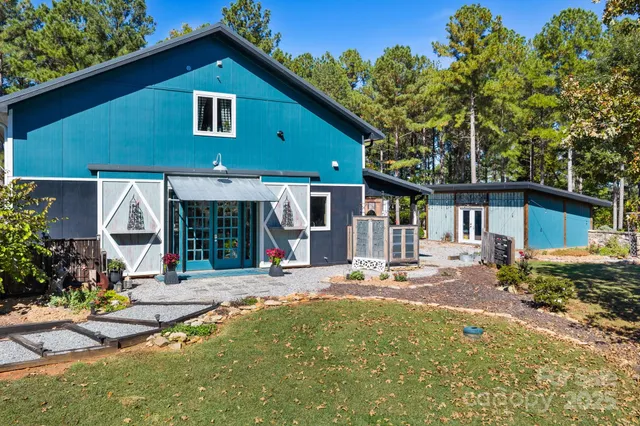 a front view of a house with a yard and potted plants