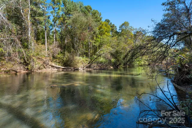 a view of a lake in between two chairs