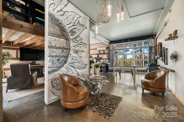 a living room with furniture and a floor to ceiling window