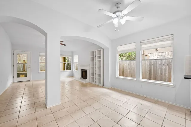 a kitchen with stainless steel appliances kitchen island granite countertop a refrigerator a stove a sink and white cabinets