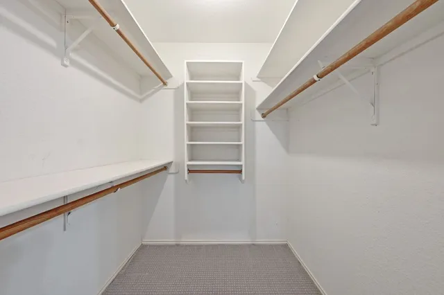 a spacious bathroom with a double vanity sink a mirror and a bathtub