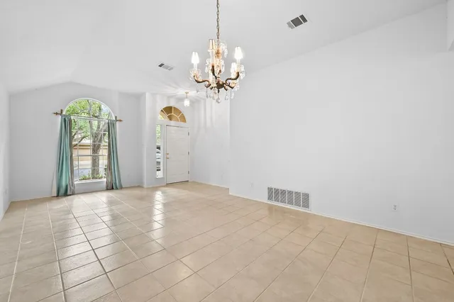 a view of a chandelier fan and entryway