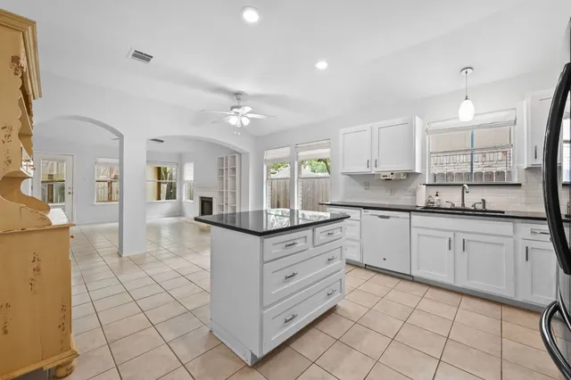 a view of a large house with a small yard and large tree