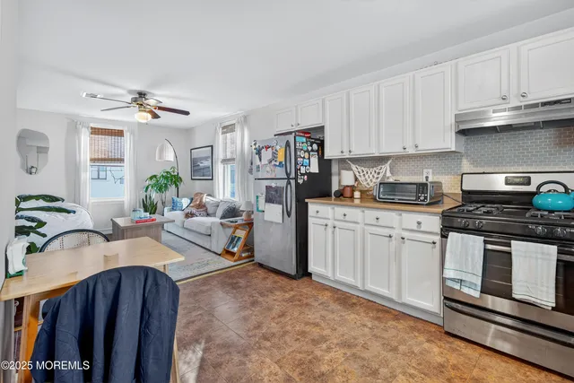a bedroom with a bed couch and a window