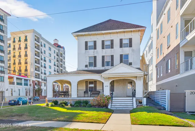 a front view of a residential apartment building with a yard