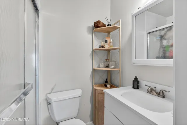 a bathroom with a sink a mirror and a toilet