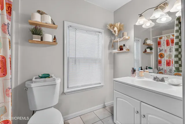 a living room with furniture a lamp and a flat screen tv