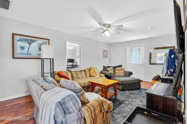 a kitchen with a dining table chairs microwave and cabinets