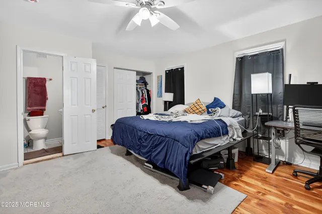 a bed sitting in a bedroom next to a window with pc on the wall