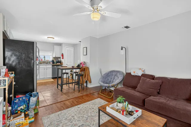 a living room with furniture a dining table and chairs