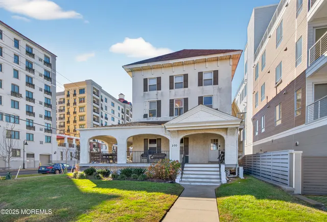 a front view of a residential apartment building with a yard