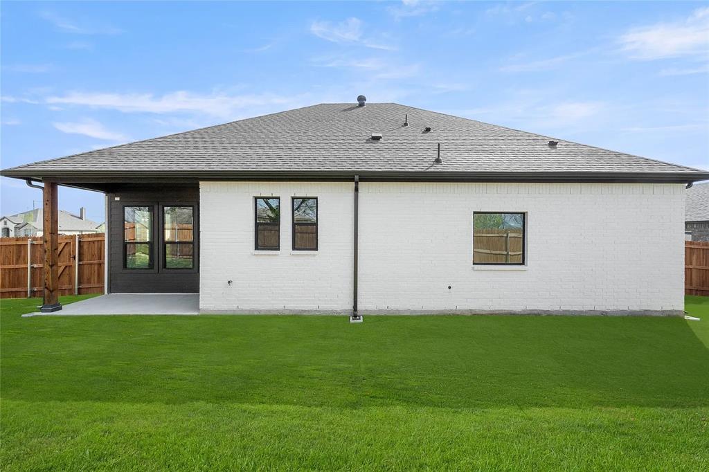 4021 Alpine Street Midlothian, TX 76065 - Photo 16 of 18 Expansive green lawn with a white brick exterior and a dark gray roof