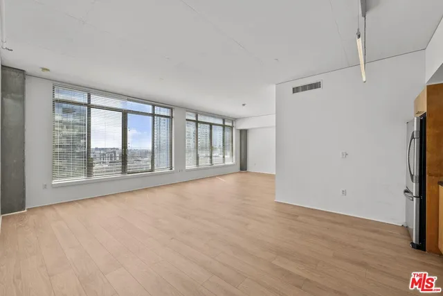 a kitchen with stainless steel appliances a refrigerator and a stove top oven