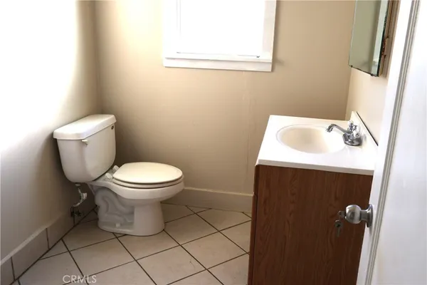 a white toilet sitting next to a white sink