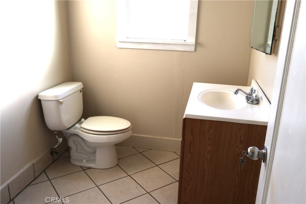 1311 6th Avenue Corning, CA 96021 - Photo 18 of 48 a white toilet sitting next to a white sink