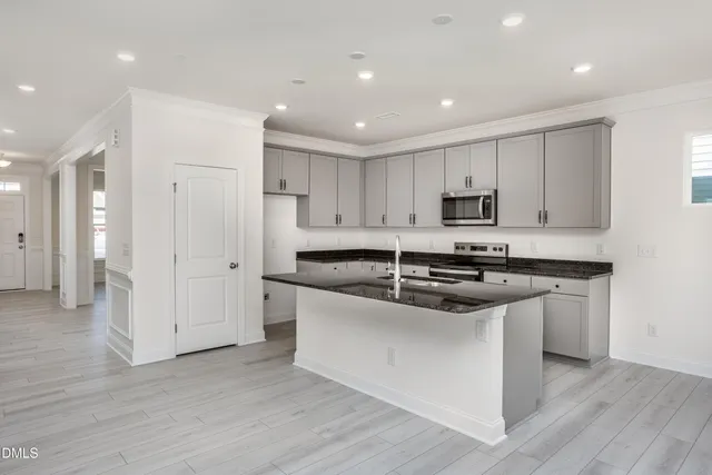 a kitchen with stainless steel appliances granite countertop a stove and a sink