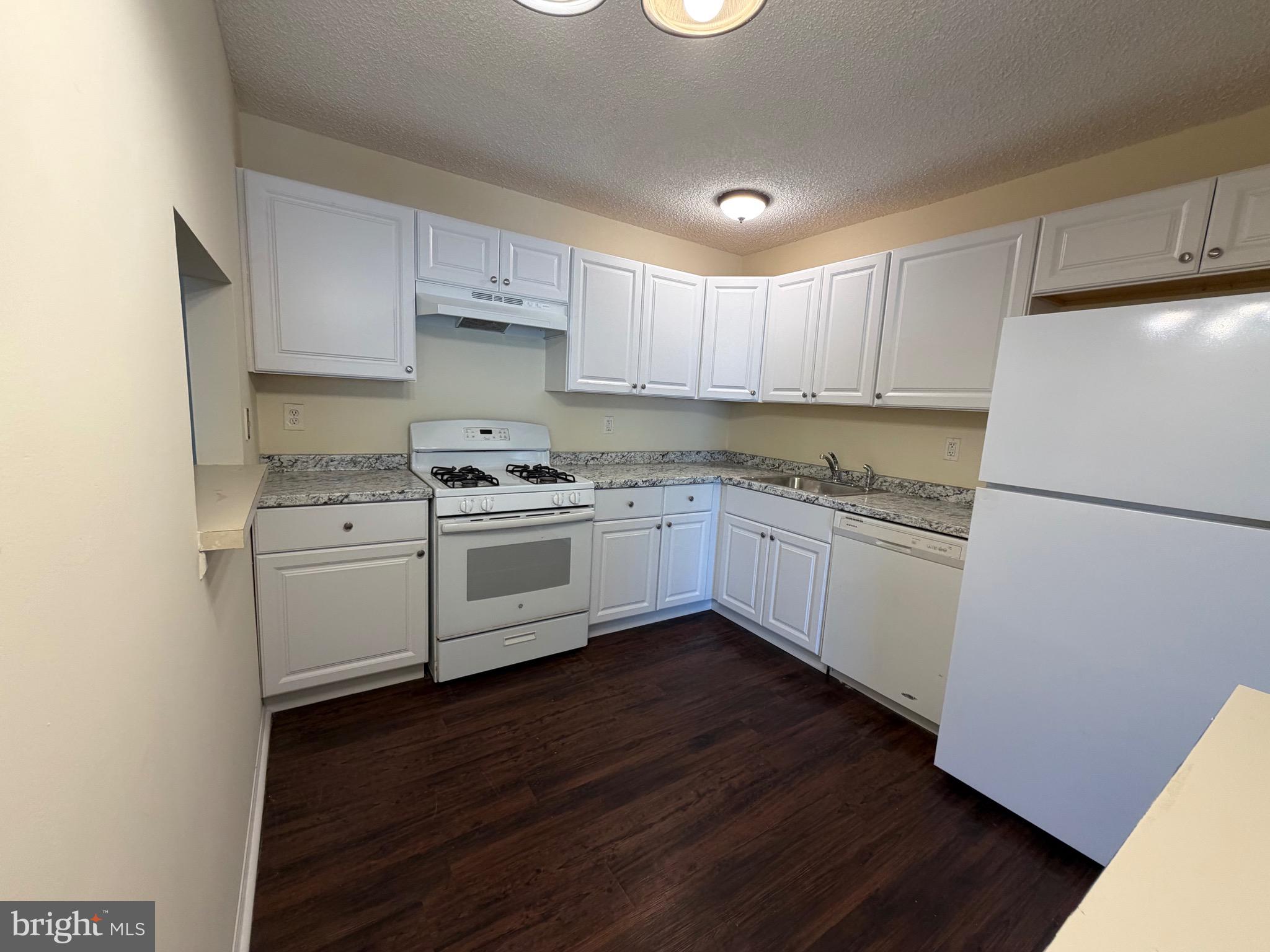 64 Mattix Run Absecon, NJ 08205 - Photo 3 of 14 a kitchen with white cabinets and white appliances