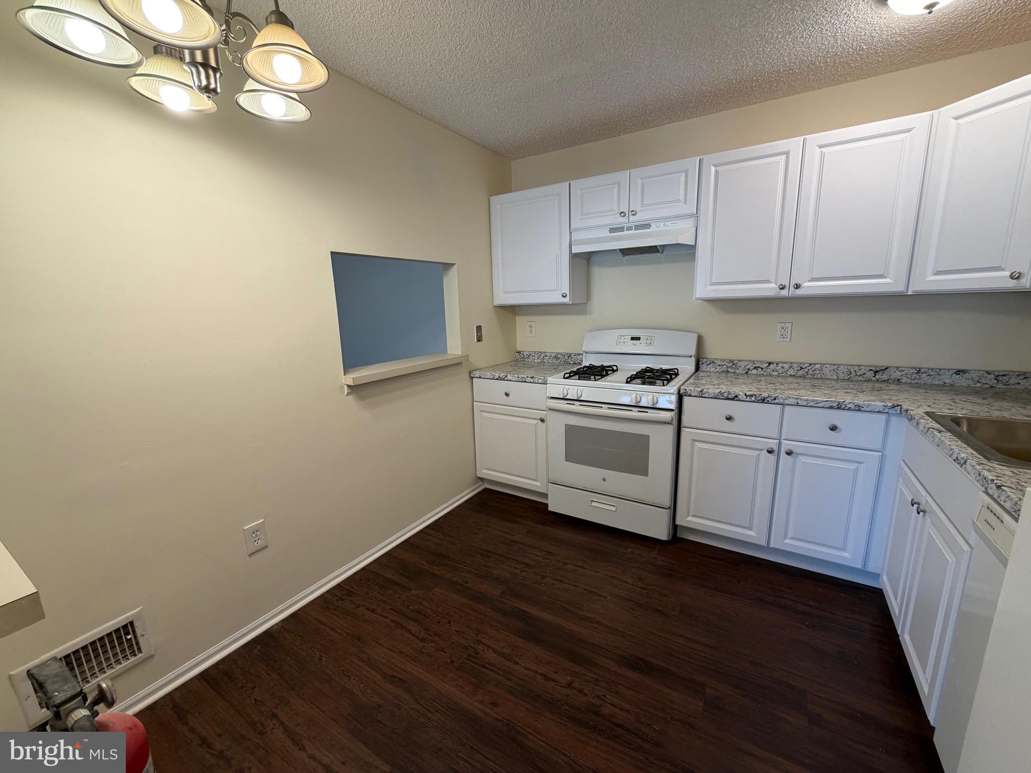 64 Mattix Run Absecon, NJ 08205 - Photo 5 of 14 a kitchen with a sink window and cabinets