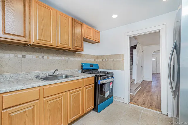 a kitchen with stainless steel appliances granite countertop a stove and a refrigerator